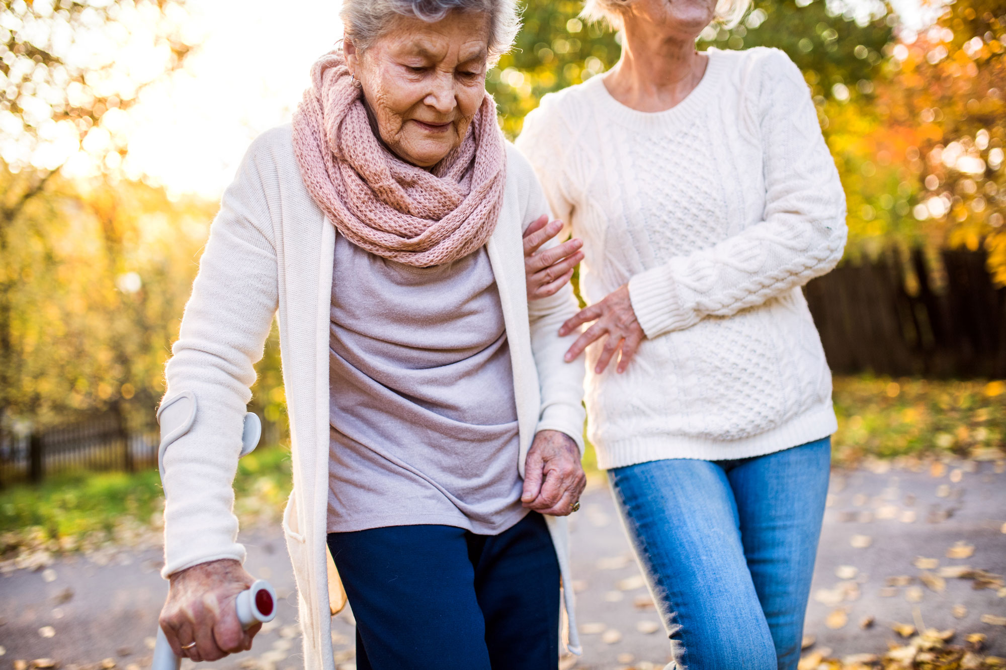 Elderly Woman Walking in Fall - Memory Care Home Solutions - Giving Back